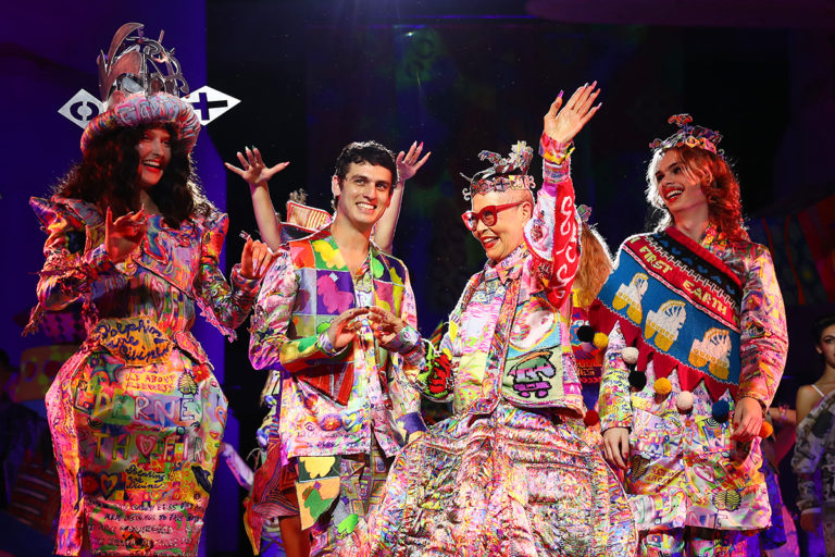 Four people dressed in colourful patterned clothing. Jordan Gogos and Jenny Kee in centre of shot